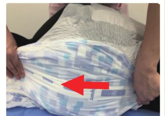 STEP4 おむつの端を押さえて足側に伸ばす